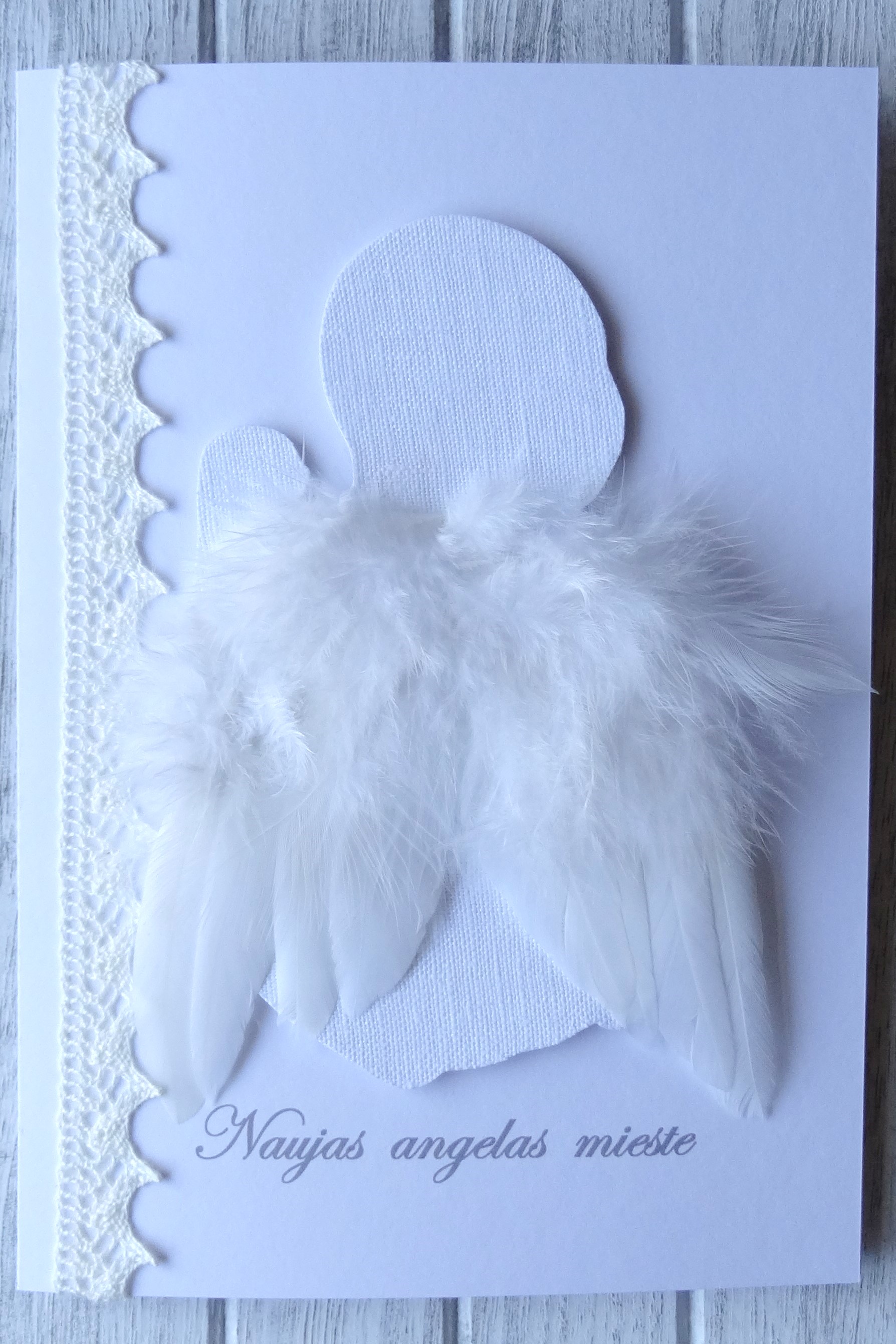 3D white linen angel with feather wings.